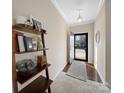 Inviting entryway with hardwood floors, a stylish accent wall shelf, and an open doorway leading to the outside at 430 Battery Cir, Clover, SC 29710