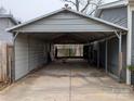 Spacious carport offers covered parking and protection from the elements, convenient and practical at 4408 Pebblebrook Dr, Charlotte, NC 28208