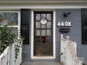 Close-up of the front door with a welcome wreath, set in a charming brick facade at 4408 Pebblebrook Dr, Charlotte, NC 28208