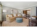 Cozy living room with comfortable seating, neutral paint, large area rug and view of dining area at 4811 Dawnridge Dr, Charlotte, NC 28226