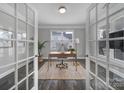 Bright home office with French doors, a modern desk setup, neutral walls, and a view to the outdoors at 5158 Mill Creek Rd, Clover, SC 29710