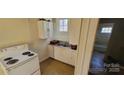 Cozy kitchen features white appliances and a double basin sink at 525 S Trenton St, Gastonia, NC 28052