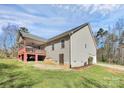 Backyard view featuring a covered deck, partial garage, and green surroundings at 5369 Concord Rd, York, SC 29745