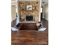 Unique sunken living room with a stone fireplace creating a cozy and inviting atmosphere at 7305 Park Vista Cir, Charlotte, NC 28226