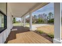 Spacious covered porch, ideal for relaxing outdoors, with views of the surrounding neighborhood at 818 E Charles St, Matthews, NC 28105