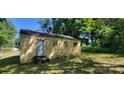 View of the back of the house with small windows and an exterior door at 819 Circle Vw, Gastonia, NC 28054