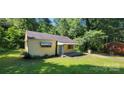 View of the house showing the front porch and the side yard with driveway at 819 Circle Vw, Gastonia, NC 28054