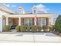 Inviting front porch with brick accents and a cozy bench, creating a warm and welcoming entrance at 8633 Sequoia Grove Ln, Charlotte, NC 28214