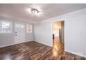 Inviting entryway with wood-look floors, a colorful rug, and access to the kitchen at 9026 Nc 10 Hwy, Vale, NC 28168