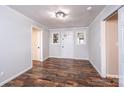 Bright entryway featuring wood-look floors, fresh paint, a modern ceiling fixture, and natural light at 9026 Nc 10 Hwy, Vale, NC 28168