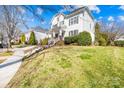 Two-story home nestled on a lush, landscaped lot with a well-maintained lawn and a sidewalk at 9433 Gilpatrick Ln, Huntersville, NC 28078