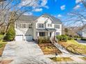 Beautiful two-story home with a front porch and a two-car garage, set on a landscaped lot at 9433 Gilpatrick Ln, Huntersville, NC 28078