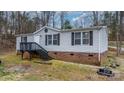 Charming single-story home with vinyl siding, brick foundation, and inviting front stairs to the door at 109 Dogwood Dr, Hickory, NC 28601