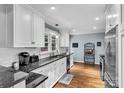 Bright kitchen featuring white cabinets, granite countertops and stainless steel appliances at 1101 Roundknob Ave, Salisbury, NC 28144
