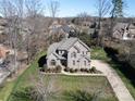 Beautiful two-story brick home with a large yard, mature trees, and a basketball hoop at 11243 Home Place Ln, Mint Hill, NC 28227