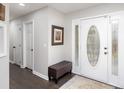 Bright entryway with a white front door, hardwood floors, and a decorative rug at 1165 Golden Maple Ln, Chester, SC 29706