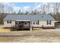 Rear view of home with a covered deck, carport, and well-maintained lawn at 1165 Golden Maple Ln, Chester, SC 29706