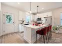 Modern kitchen featuring stainless steel appliances, a central island, and sleek white cabinetry at 117 Mountain View St, Gastonia, NC 28052