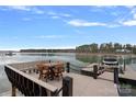 Lakeside boat dock with outdoor seating, offering serene views and access to water activities at 130 Brick Kiln Way, Mooresville, NC 28117