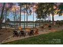 Lakeside fire pit area with comfortable seating, perfect for relaxing evenings by the water at 130 Brick Kiln Way, Mooresville, NC 28117