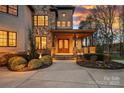 Elegant stone-accented facade with covered entryway featuring a double-door entrance and manicured landscaping at 130 Brick Kiln Way, Mooresville, NC 28117