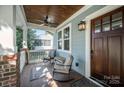 Cozy front porch with comfortable seating, ceiling fan, and wood ceiling at 130 N Smallwood Pl, Charlotte, NC 28216