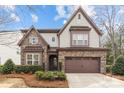 Beautiful two-story home features stone accents, a two-car garage, and manicured landscaping at 13725 Laughing Gull Dr, Charlotte, NC 28278