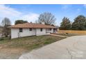 This home boasts a well-kept lawn, brick walkway and a white brick exterior with a new fence at 1601 Mooresville Rd, Salisbury, NC 28147