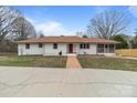 Beautiful single-story home featuring a bright red door and well-manicured front yard and brick walkway at 1601 Mooresville Rd, Salisbury, NC 28147