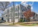 New townhome exterior featuring gray siding, multiple windows, balconies and attached garages at 1659 Duckworth Ave, Charlotte, NC 28208