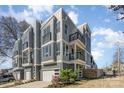Modern townhome exterior with gray siding, balconies, and attached garages, showcasing contemporary design at 1659 Duckworth Ave, Charlotte, NC 28208