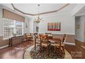 Elegant dining room featuring hardwood floors, tray ceilings, a chandelier and a large window at 1668 Onyx Rdg # 116, Fort Mill, SC 29708