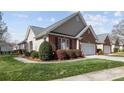 Beautiful brick home with a manicured lawn, vibrant flower bushes, and charming curb appeal at 1668 Onyx Rdg # 116, Fort Mill, SC 29708