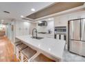 Modern kitchen featuring an island with seating, stainless steel appliances, and ample cabinet space at 18 Pickett Ave, Spencer, NC 28159