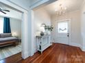 Bright foyer with hardwood floors, chandelier, and doorway to bedroom at 225 Marion St, Rock Hill, SC 29730