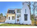 Beautifully designed exterior of a modern white brick home with unique architectural details and dark window trim at 2325 Winthrop Ave, Charlotte, NC 28203