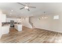 Spacious open-concept living room and kitchen featuring hardwood floors, recessed lighting, and a ceiling fan at 2821 New Pineola Rd, Charlotte, NC 28208