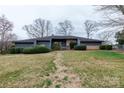 Charming single-story home with a well-manicured front yard and mature landscaping at 404 Downing Dr, Kings Mountain, NC 28086