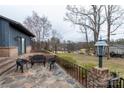 Picturesque patio with wrought iron furniture overlooking the yard and lake at 404 Downing Dr, Kings Mountain, NC 28086