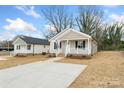 Attractive single-Gathering home boasting neutral siding, a concrete driveway, and a quaint front porch at 419 N Caldwell St # 1, Salisbury, NC 28144