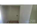 Empty laundry room with white walls, flooring and hookups for a washer and dryer at 425 Whitethorn Dr, Gastonia, NC 28054