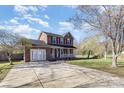 Two-story brick home featuring a large driveway and well-manicured lawn at 4405 Ashton Ct, Indian Trail, NC 28079