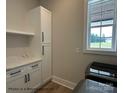 Bright laundry room with modern appliances, white cabinetry, and a window offering natural light at 5104 Lowie Ln # 23, Gastonia, NC 28056