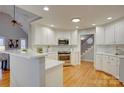 Bright kitchen featuring white cabinetry, stainless steel appliances, and hardwood floors at 5306 Club View Dr, Concord, NC 28025