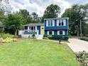 Charming two-story home with a well-manicured lawn, inviting front porch, and a bright yellow front door at 7812 Highbanks Ct, Charlotte, NC 28212