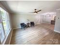 Bright and airy living room featuring neutral walls, modern ceiling fan, and hardwood floors throughout at 7812 Highbanks Ct, Charlotte, NC 28212