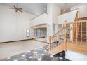 Spacious living room with high ceilings, a wooden staircase, and large windows at 8909 Abberley Ct, Huntersville, NC 28078