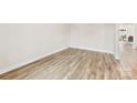 A spacious room with wood floors and neutral walls at 916 Clementine Rd, Monroe, NC 28110