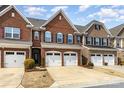 Attractive brick townhome with a two-car garage and manicured front yard at 105 Burlingame Ct # B, Mooresville, NC 28117
