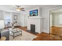 Bright living room with hardwood floors, a painted brick fireplace, and fresh decor at 1105 Vanizer St, Charlotte, NC 28208